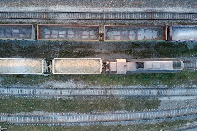 Aerial view of cargo train loaded with crushed sandstone\
materials at mine factory railway transportation of open pit mining\
ore