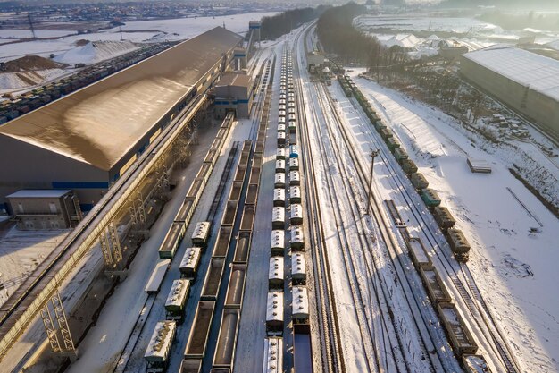 Photo aerial view of cargo train loaded with crushed stone materials at mining factory railway transportation of grinded limestone ore