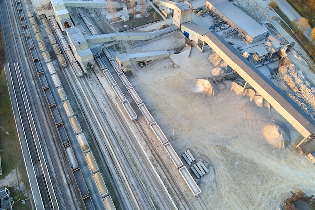 Aerial view of cargo train loaded with crushed stone materials at mining factory Railway transportation of grinded limestone ore