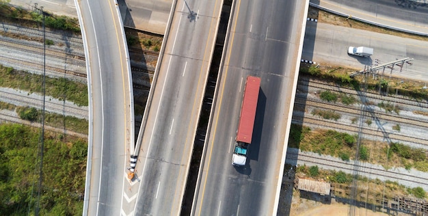 Photo aerial view of cargo truck on highway road with red container, transportation concept.,import,export logistic industrial transporting land transport on the asphalt expressway