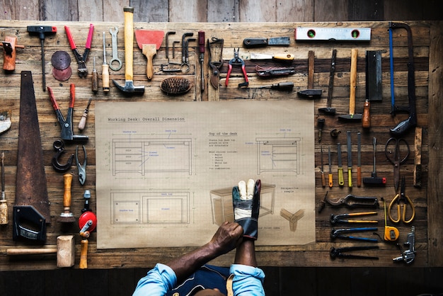 Aerial view of carpenter craftsman with furniture sketch plan