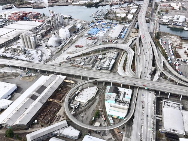 Photo aerial view of cars moving on street by industries