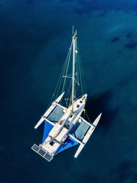 Aerial view of catamaran anchoring on coral reef