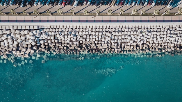Aerial view of cement cube blocks protecting the shore from the waves in the port in Malaga
