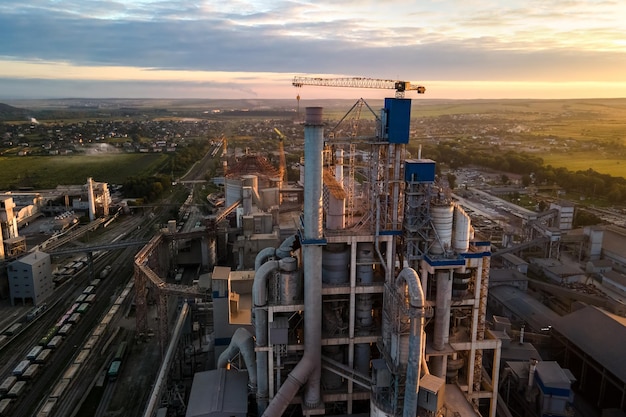 Aerial view of cement factory tower with high concrete plant structure at industrial production area Manufacturing and global industry concept