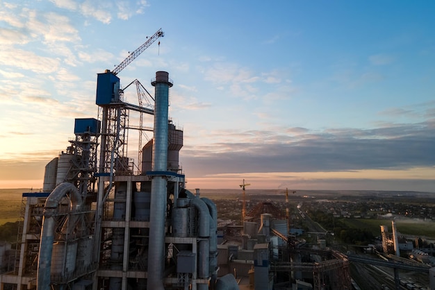 Aerial view of cement factory tower with high concrete plant structure at industrial production area Manufacturing and global industry concept