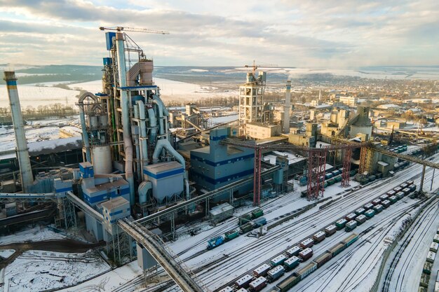 Aerial view of cement plant with high factory structure at industrial production area.