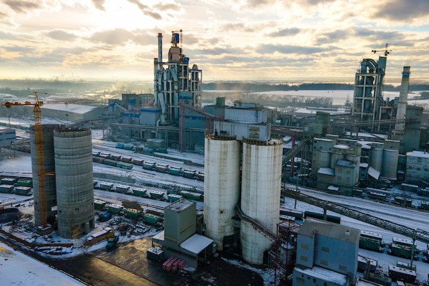 Aerial view of cement plant with high factory structure and tower crane