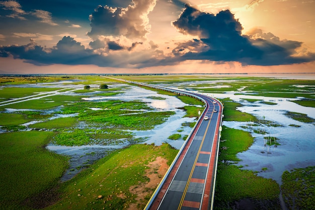 Aerial view of Chalerm Phra Kiat road at sunset in Thale Noi, Phatthalung, Thailand