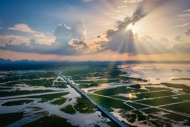 Aerial view of Chalerm Phra Kiat road at sunset in Thale Noi, Phatthalung, Thailand