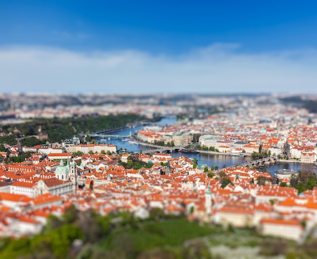 Aerial view of Charles Bridge over Vltava river and Old city from Petrin hill Observation Tower with tilt shift toy effect shallow depth of field Prague Czech Republic