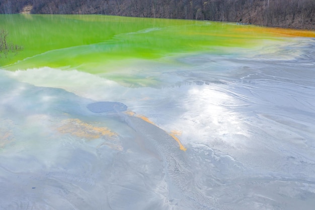 Aerial view of chemical residuals flooding a lake from a copper mine exploitation