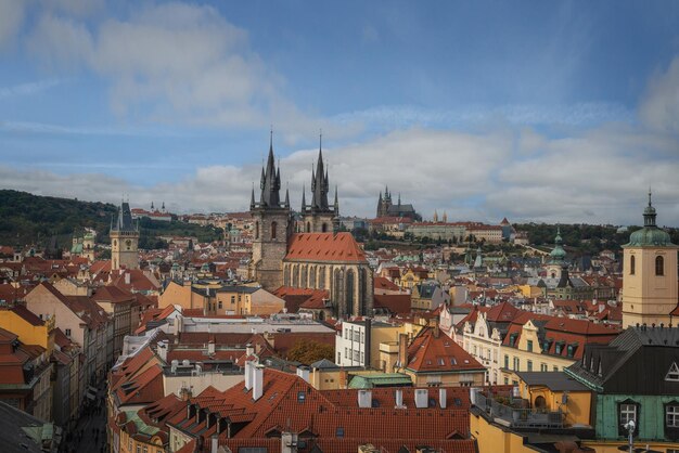 Aerial view of church of our lady before tyn and old town hall tower with prague castle on background prague czech republic