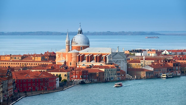 Aerial view of Church of Santissimo Redentore or Holy Redeemer Bird view of Giudecca Canal and Venetian Lagoon with blue sky Beautiful Venice Italy Europe