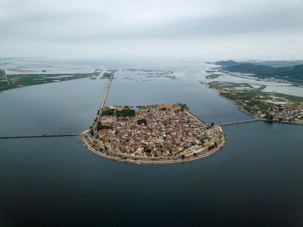 Aerial view of city amidst sea against sky