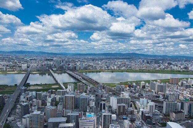 Aerial view of city by river against sky