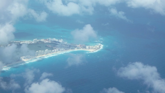 Aerial view of city by sea against sky