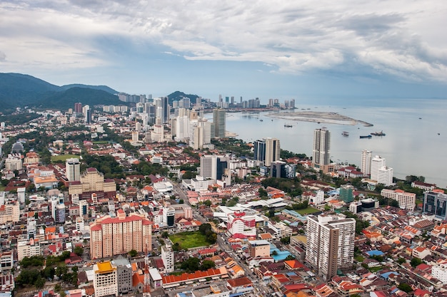 Aerial view of city of Georgetown and coast with ships on the island of Penang in Malaysia