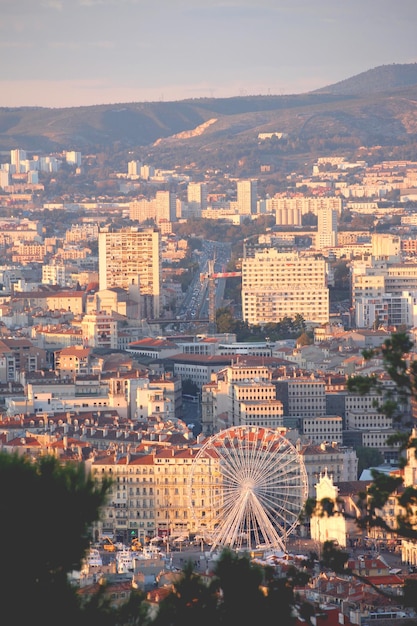 Aerial view of a city at sunset with the skyline in the background