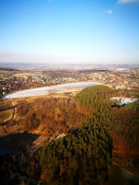 Aerial view of cityscape and mountains against sky