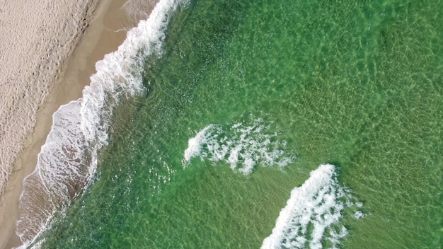 Aerial view of clear turquoise sea and waves