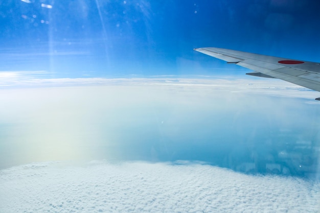 Aerial view of clouds seen through airplane window