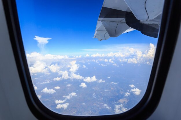 Aerial view of clouds seen through airplane window