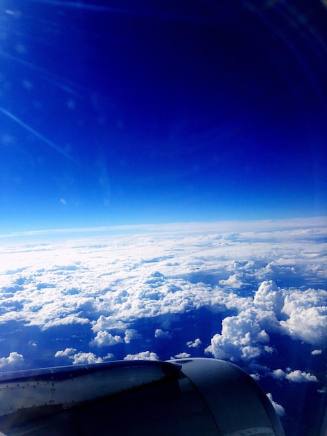 Aerial view of cloudy sky seen through airplane window