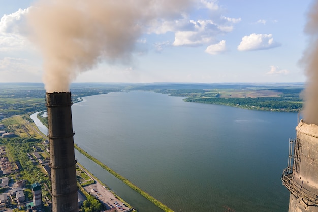 Aerial view of coal power plant high pipes with black\
smokestack polluting atmosphere. electricity production with fossil\
fuel concept.