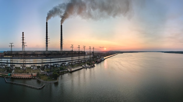 Aerial view of coal power plant high pipes with black smokestack polluting atmosphere Electricity production with fossil fuel concept