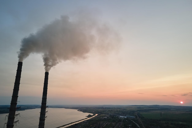 Aerial view of coal power plant high pipes with black
smokestack polluting atmosphere electricity production with fossil
fuel concept