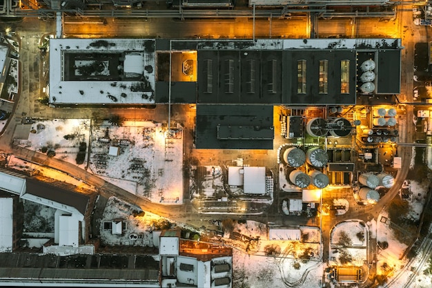 Photo aerial view of a coalfired power plant in the evening sending a power line to the city