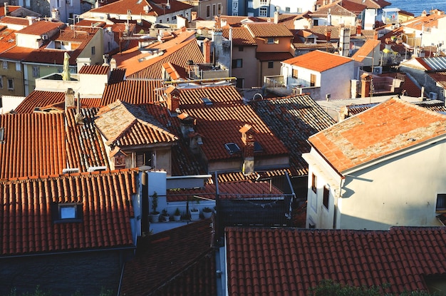 Aerial view, coast of Slovenia. Scenic view of red roofs of historical center. Old town Piran. Sea.