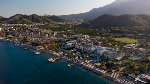 Aerial view of of coastal area of Kemer Turkish beach resort city Beautiful Mediterranean Sea Turquoise colors of water Drone shot