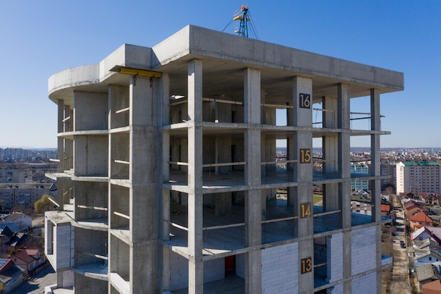 Aerial view of concrete frame of tall apartment building under construction in a city