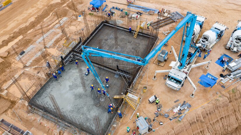  Aerial view construction worker pouring concrete at construction site