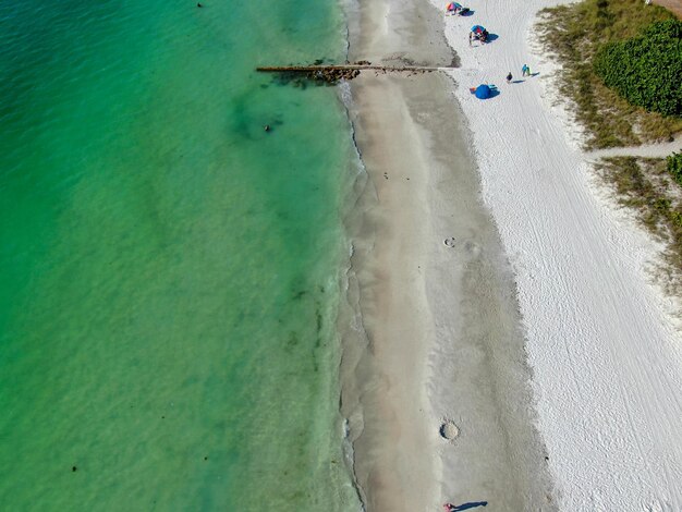 Aerial view of Coquina Beach white sand beach and turquoise water in Anna Maria Island Florida USA