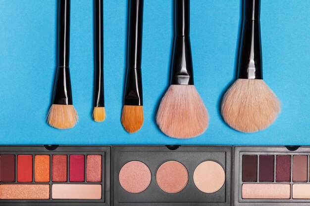 Aerial view of a cosmetic beauty products spilling out onto a pink background