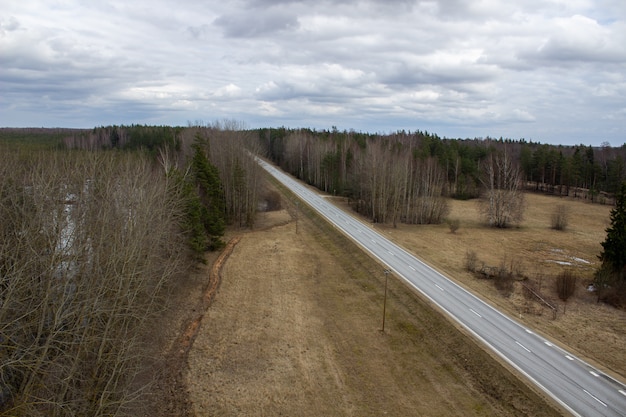 Aerial view of country road through the forest