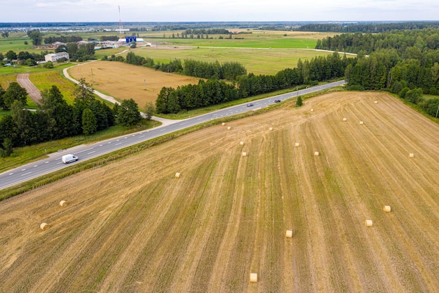 aerial view of countryside road cultivated fields and forest