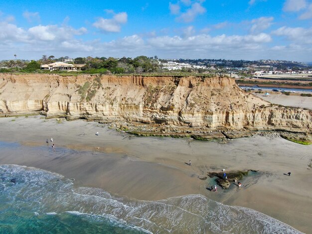 Aerial view of Del Mar North Beach, California coastal cliffs and House with blue Pacific ocean