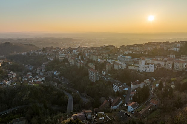 Aerial view of dense historic center of Thiers town in PuydeDome department AuvergneRhoneAlpes region in France Rooftops of old buildings and narrow streets at sunset