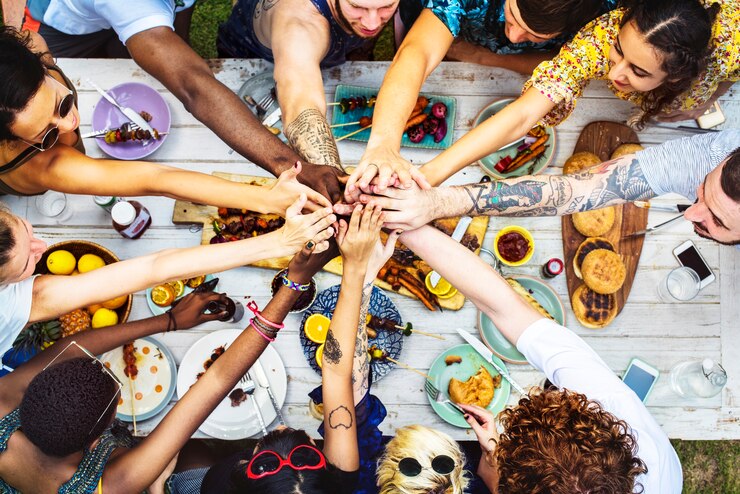 Photo aerial view of diverse hands join together