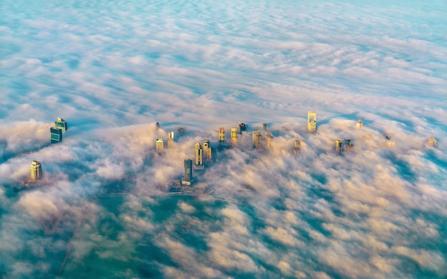 Aerial view of Doha through the morning fog, the capital of Qatar in the Persian Gulf