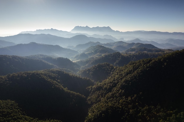 Aerial view of Doi Luang Chiang Dao with mountain layer and fog on sunny day in tropical rainforest at national park