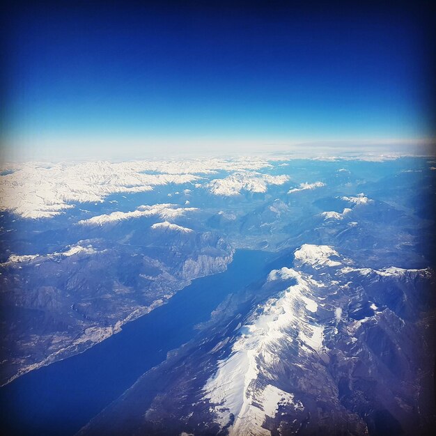 Aerial view of dramatic landscape against clear blue sky