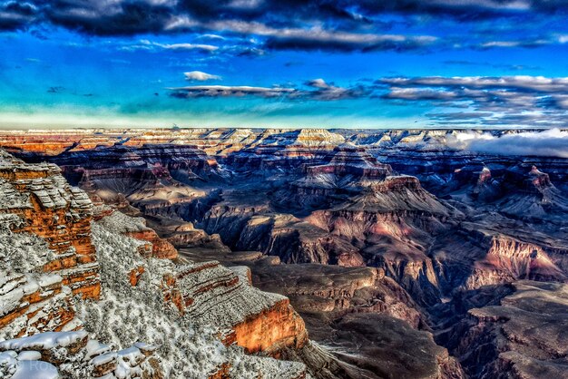 Aerial view of dramatic landscape against sky during winter