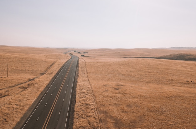 Aerial view of dry boundless agricultural fields in California