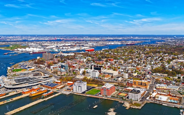 Aerial view of Dry Dock and Repair and Port Newark and Global international shipping containers, Bayonne, New Jersey. NJ, USA. Harbor cargo. Staten Island with St George Ferry terminal, New York City