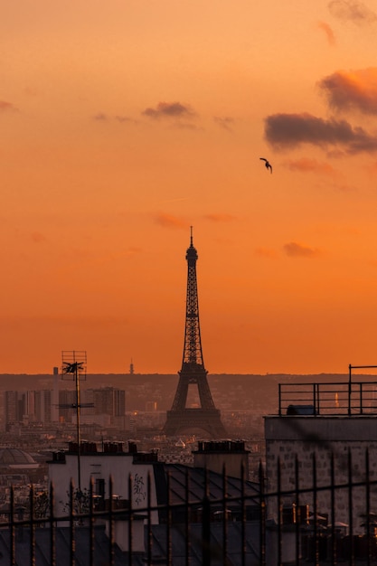 aerial view of eiffel tower against sky in city during sunset